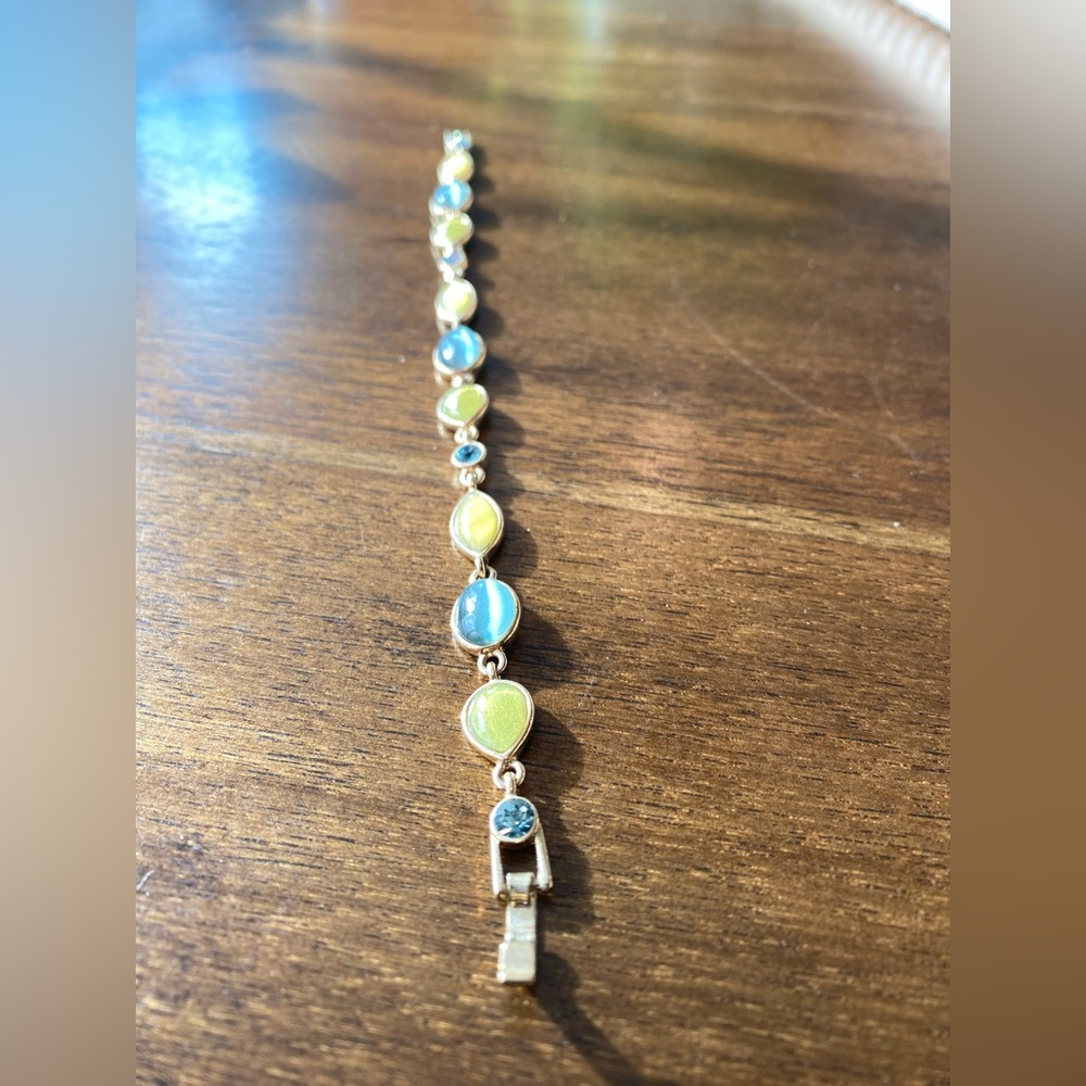 Gold tone bracelet with green/blue and yellow beads.